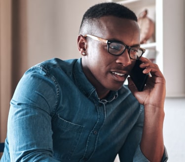 dark haired man on the phone